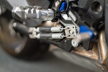 Close-up view of motorcycle part with intricate design and mechanical components in a workshop setting