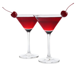 Martini cocktail with cherries in glasses on white background