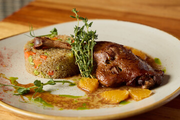 Enjoy a Delicious Roast Duck with Herb Infused Couscous and a refreshing Citrus Garnish