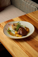 An exquisite gourmet plated dish showcasing colorful garnishes and a delightful sauce