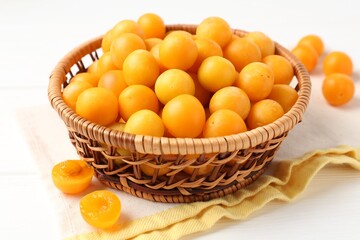 Ripe yellow cherry plums on white wooden table, closeup