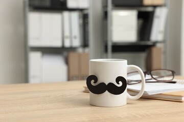 Happy Father's Day. Cup with paper moustache, books and glasses on wooden table, space for text