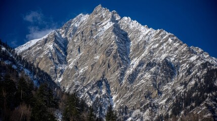A stunning mountain landscape at sunset, with golden light illuminating the peaks and a serene valley below,