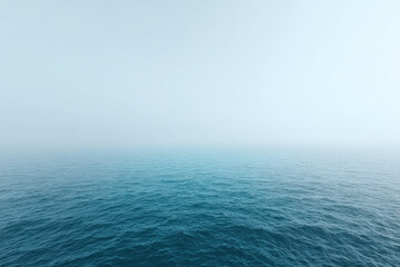 Obraz premium aerial view of tranquil ocean surface enveloped in fog captures mesmerizing beauty of nature