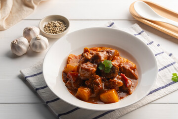 Baked Pork Ribs with Pineapple,Sweet and sour baked Pork Baby Back Ribs or pork cartilage with sliced pineapple and tomato sauce in a plate.