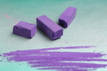 Violet chalk pastels and scribble on color background, closeup