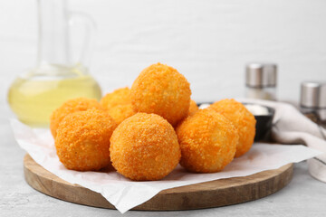 Delicious fried croquette balls on gray table, closeup