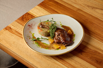 An exquisite gourmet dish featuring succulent meat combined with colorful accompaniments