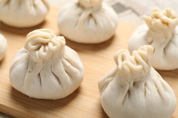 Many uncooked khinkalis (dumplings) on table, closeup