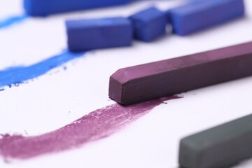 Colorful chalk pastels on white background, closeup