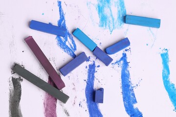 Colorful chalk pastels on white background, flat lay