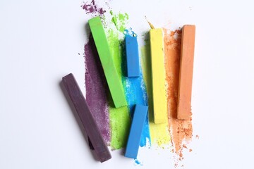 Colorful chalk pastels on white background, flat lay
