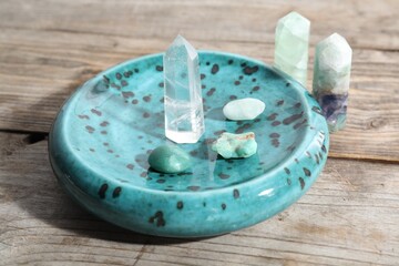 Many different healing stones on wooden table, closeup