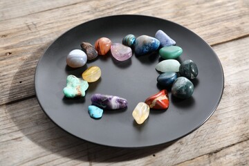 Many different healing stones on wooden table, closeup