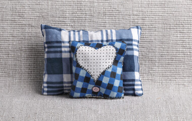 Blue checked pillows with heart shape on the sofa
