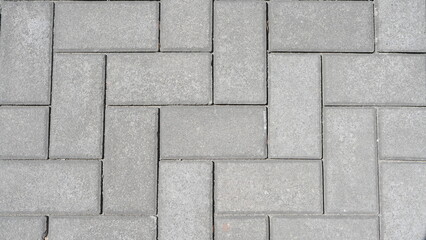 Grey concrete pavement for a sidewalk and driveway. Paving slabs texture and background.
