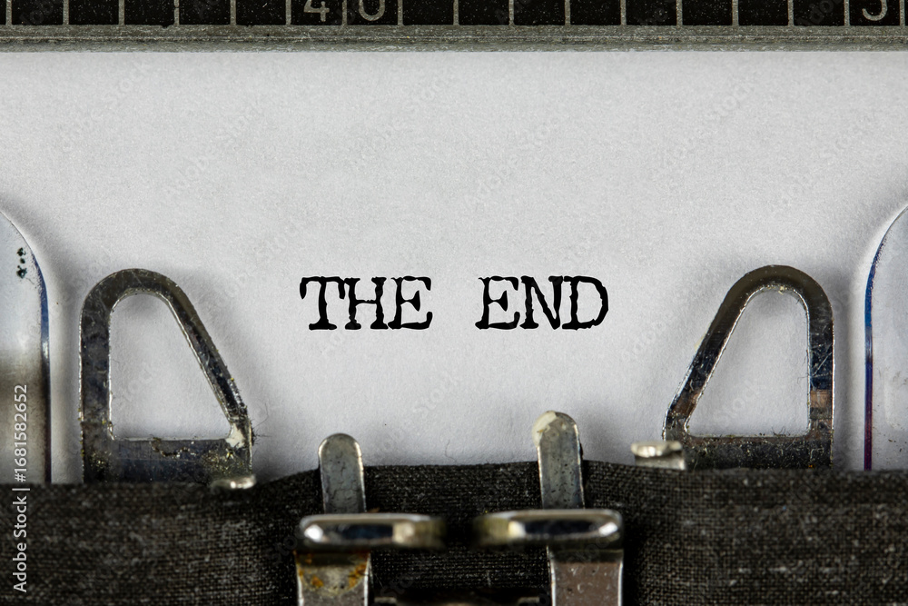 Fototapete closeup of a blue retro typewriter and the text the end written with it in a yellowish foil. close u