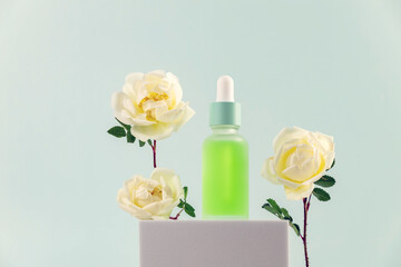 a bottle of essential oil with a pipette and cream rose flowers on a white podium. The concept of skin care using natural cosmetics