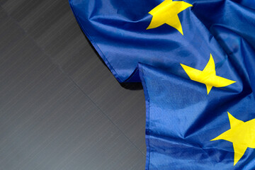 European Union flag placed on solar panel, symbolizing renewable energy, sustainability, green future, and clean power in Europe