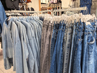 Denim collection on display in trendy clothing store during daytime shopping