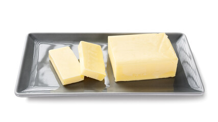 Sliced pieces of butter on a plate, isolated on white background