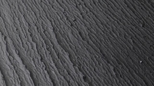 Detailed Close-Up View of Textured Black Slate Surface Emulating Grunge Aesthetic