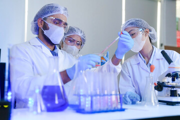 A team of scientists in a high-tech lab collaborates on genetic and medical research. They use...
