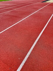 Fototapeta premium Red track lanes leading to success, ideal for sports, fitness, competition, and achieving goals