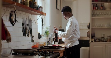 Pepper, cooking and meat with black man in kitchen for personal chef, nutritionist and meal prep. Healthy food, seasoning and home cook with person in house for steak, dinner and cuisine protein