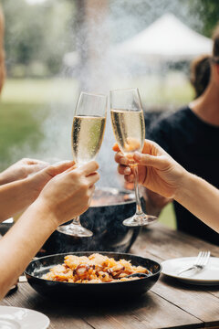 Hand holding glass of champagne, people cheering, friends, party nightclub, wedding, cheering, family, sparkling wine, luxury, 4K, vertical video, social media, 9:16, insta story