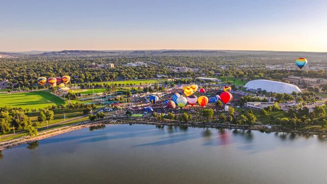 Hot air balloons taking off from launc field on a sunny day, aerial hyperlapse, 4K