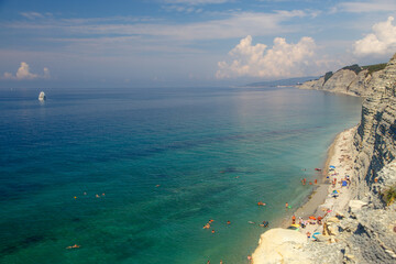 Gelendzhik resort, Sosnovka beach. Black sea. High white rock, pine trees growing on top. Beach at...