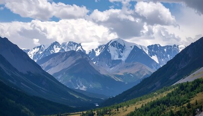 Fototapeta premium Majestic mountain range with snow-capped peaks under a cloudy sky.