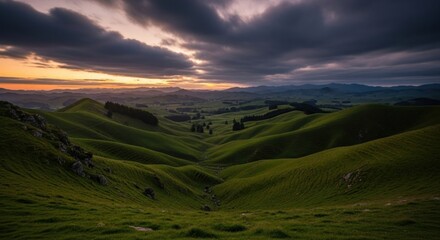 Fototapeta premium Lush green hills and valleys at sunset, dramatic clouds