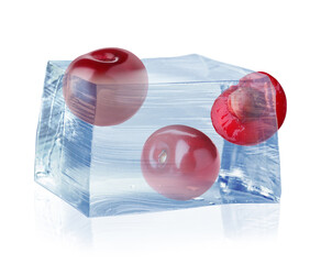 Fresh cherries in clear ice cube isolated on white