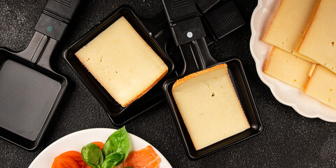 Raclette cheese portion slicing natural product tasty snack fresh delicious gourmet food background...