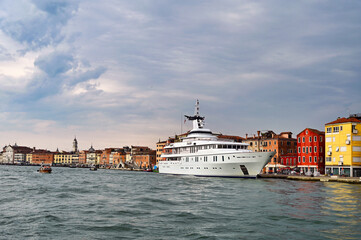 A large luxury white yacht anchored in Venice, Italy