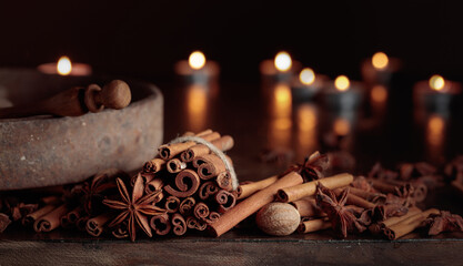 Cinnamon sticks, anise, and nutmeg on a old wooden table.