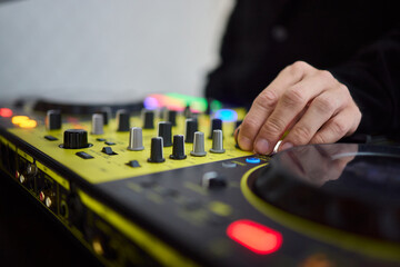 Witness the DJ mixing equipment performing live and in action at a vibrant music event