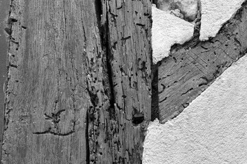 Weathered Wooden Beam and Cracked Plaster in Black and White
