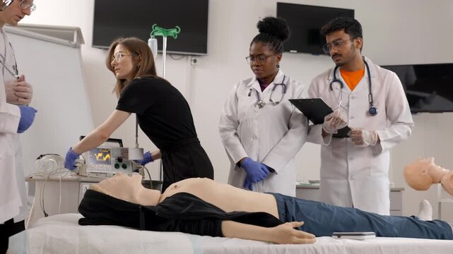 Instructor teaching first aid cardiopulmonary resuscitation course and use of automated external defibrillator workshop