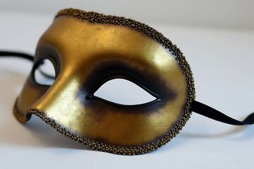 Ornate golden masquerade mask with intricate details and elegant design for theatrical performances and costume events