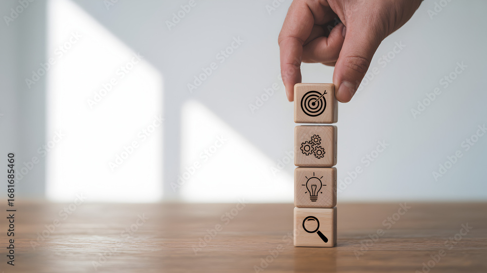 Poster hand stacking wooden blocks with icons of target gears light bulb and magnifying glass representing 