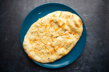 Freshly Baked Garlic Naan on a Blue Plate top view of Bangladeshi food