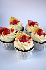 chocolate cupcakes with cream cheese frosting and festive decor. Valentine's day or birthday dessert. Beautiful festive food for a wedding or children's party.