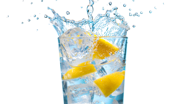 Refreshing lemon slices splashing into a tall glass filled with ice and sparkling water isolated on transparent background