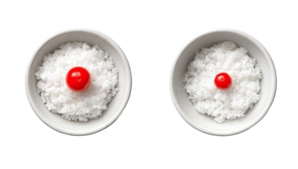Two white bowls of rice, one larger than the other, each topped with a cherry tomato