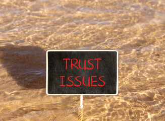 Trust issues symbol. Concept word Trust issues on beautiful black blackboard. Beautiful Red sea...