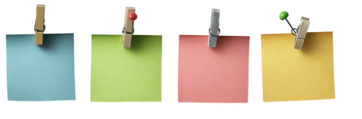 Four blank notepads, each a different color, secured with clothespins