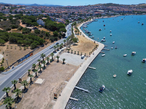 Alibey Island bathed in sunlight, with crystal Aegean waters flowing endlessly along its natural shoreline.